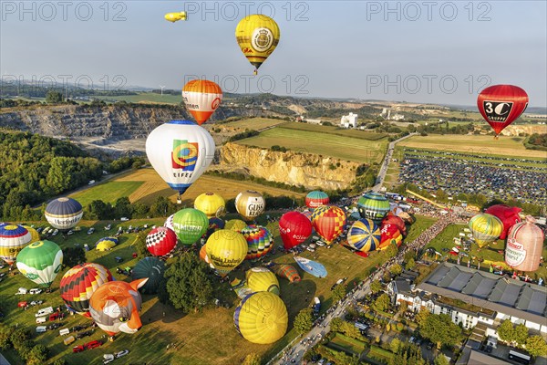 Colourful hot-air balloons at mass launch, crowd on fairground, hot-air balloon festival, 26th