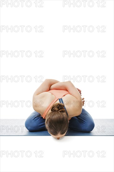 Woman doing Asthanga Vinyasa Yoga asana Yoga mudrasana (yoga mudra), psychic union pose isolated on
