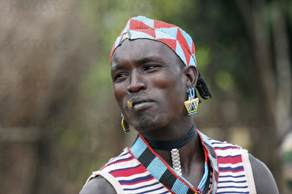 Man from the Bana tribe, Bena in traditional dress with colourful beads in Key Afar, Ethiopia,