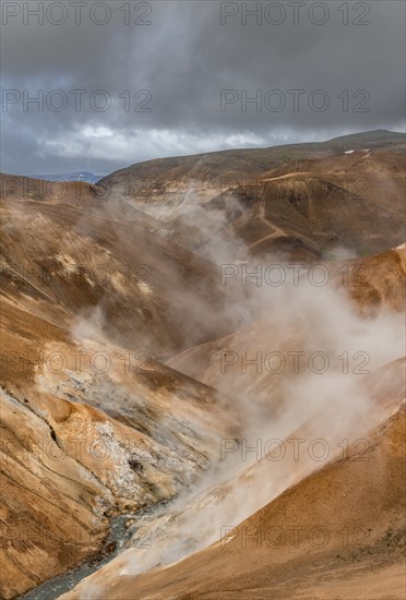 Steaming stream between colourful rhyolite mountains, Hveradalir geothermal area, Kerlingarfjöll,