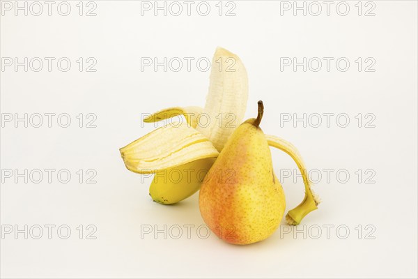 Half peeled banana with pear, studio shot, white background, healthy food