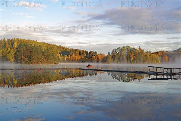 Fog drifts over a calm lake, foliage colouring, October, Bullaren, Västrä Götland, Sweden, Europe