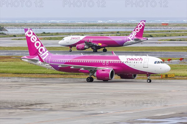 Airbus A320 Peach aircraft with registration JA204P at Okinawa Airport (OKA) in Naha, Japan, Asia