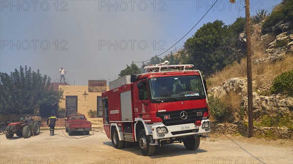 Taverna, threatened by fire, firefighting, fire engine, smoke, fire, Falassarna, west coast, Crete,