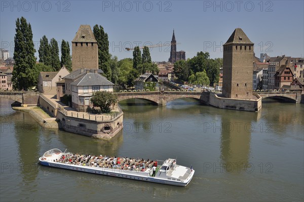 Excursion boat on the River Ill at the Ponts Couverts bridge with towers, UNESCO World Heritage