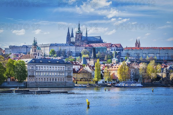 View of Gradchany Prague Castle and St. Vitus Cathedral in daytime over Vltava river