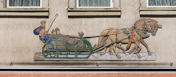 Historical relief on a house facade, people in a horse-drawn sleigh, Emmendingen,