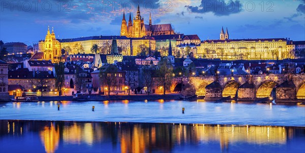 Panorama of Prague Castle and St. Vitus cathedral in twilight with dramatic sky. Prague, Czech