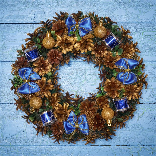 Christmas wreath on blue painted wooden background