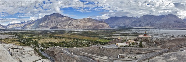 Panorama of Nubra valley in Himalayas with giant Buddha statue in Diskit, Ladakh, India, Asia