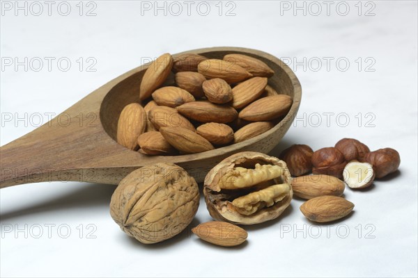 Wooden ladle with various nuts