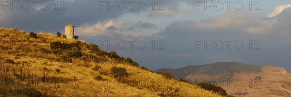 All around, panorama shot, evening light, autumn hill landscape, brown fields, dramatic cloudy sky,