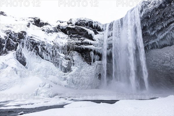 Skogafoss waterfall, snowy and icy rock face, Sudurland, Iceland, Europe