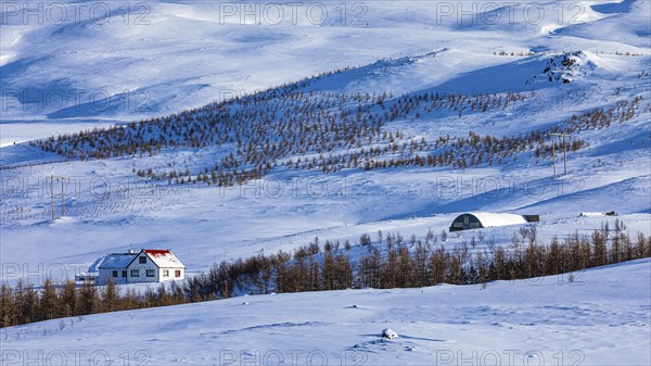 Farmhouse in snow-covered hilly landscape, near Akureyri, North Iceland Eyestra, Iceland, Europe