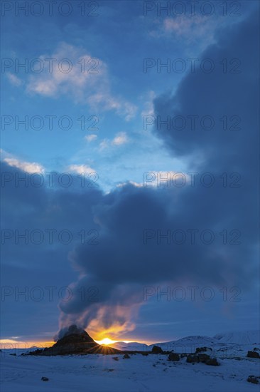 Mud pot with steam source at sunrise, Hverir solfataras field, fumaroles, snow-covered geothermal