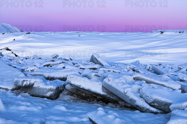 Icefall at the river Skialfandafljot at blue hour, near the waterfall Godafoss, snow-covered