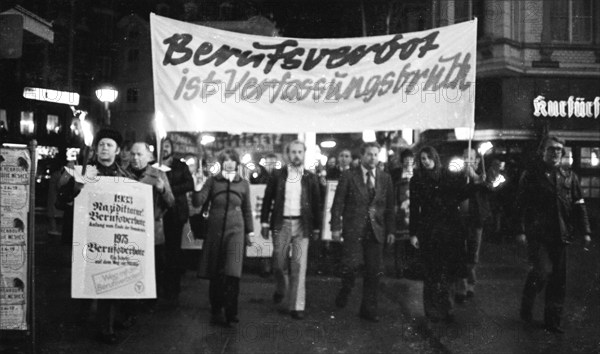 Nazi victims, some in concentration camp uniforms, demonstrated against the occupational bans
