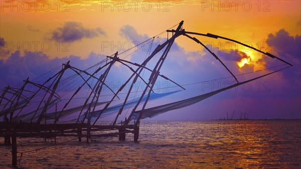 Panorama of Kochi tourist attraction, chinese fishnets on sunset with grunge texture overlaid. Fort