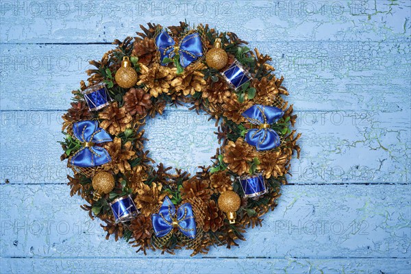 Christmas wreath on blue painted wooden background