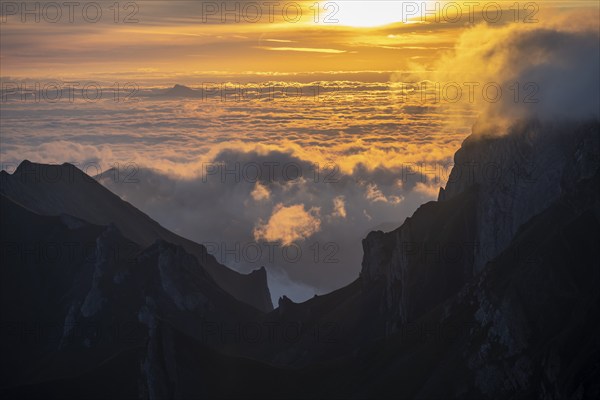 Sunrise, sun shining over mountains in fog, Säntis, Appenzell Ausserrhoden, Appenzell Alps,