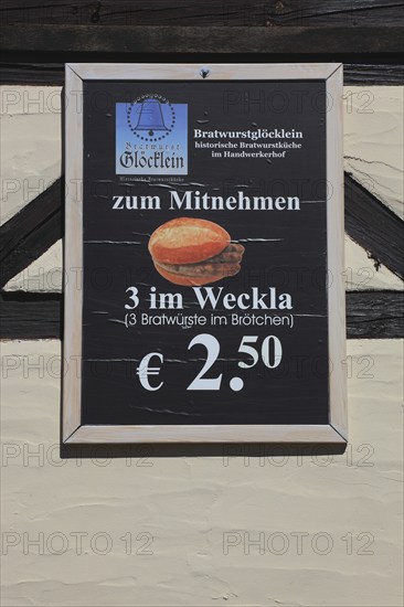 In the old town of Nuremberg, advertising sign of the restaurant, Bratwurstglöcklein, three in the