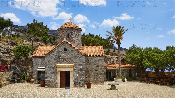 Church, stone building, red tiled roof, dome, palm tree, forecourt, Koudouma, Orthodox monastery,