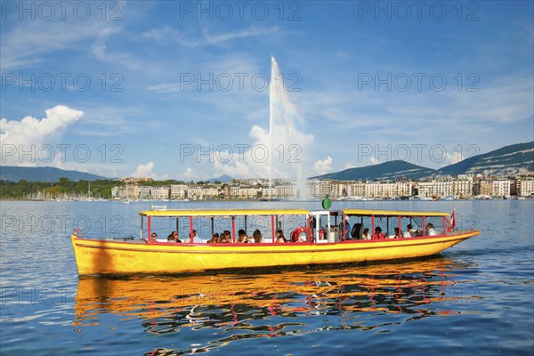 The Jet d'eau, and the Mouettes genevoises in sunshine and blue sky, landmark in the Geneva harbour