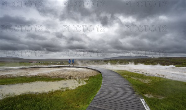 Tourists on a wooden path, steaming hot springs, Hveravellir geothermal area, Icelandic highlands,