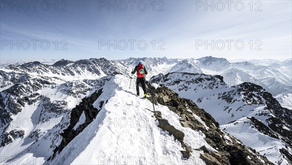 Ski tourers at the summit of the Sulzkogel, view of the peaks of the Stubai Alps, mountain