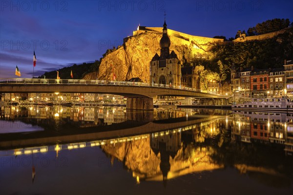 Night view of Dinant town, Collegiate Church of Notre Dame de Dinant over River Meuse and Pont