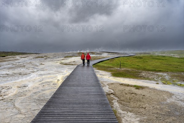 Tourists on a logging road between hot springs, Hveravellir geothermal area, Icelandic Highlands,