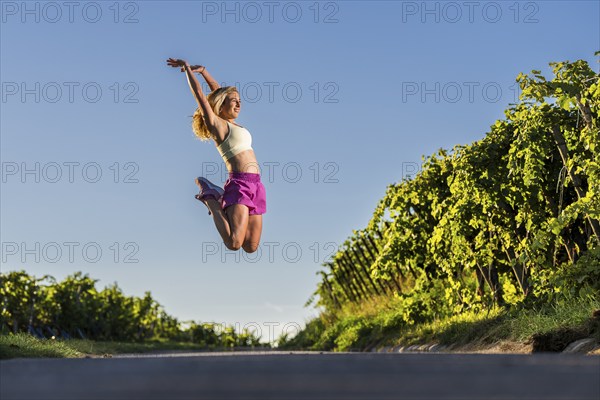 Young woman in Fitness training, vineyard at Grossheppach, Remstal valley, Baden Württemberg,