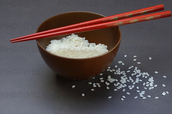 Rice, white rice in bowl with chopsticks, uncooked