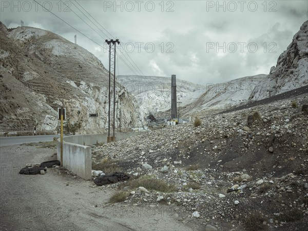 Chimney of the smelter, in the foreground a spoil heap contaminated with heavy metal residues, La