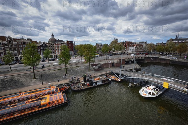 AMSTERDAM, NETHERLANDS, MAY 9, 2017: Aerial view of Amsterdam canal with tourist boats near