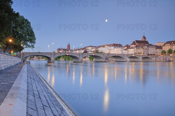 View of the old town of Basel illuminated at night with the Basel Cathedral, St. Martin's Church,
