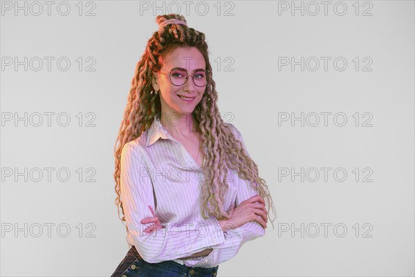 Young woman with dreadlocks crossed hands on chest