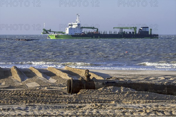 DEME trailing suction hopper dredger Uilenspiegel at sea, used for sand replenishment, beach