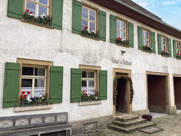 Historic schoolhouse of Bubsheim from 1830 with green shutters rebuilt in the open-air museum