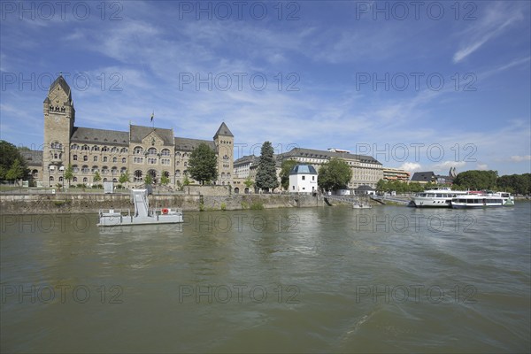 Government building in neo-Romanesque style and gauge house on the banks of the Rhine, quay, pier,