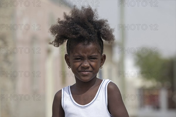 Close up portrait of Creole girl with frizzy hair on the island Boa Vista, Cape Verde, Cabo Verde,