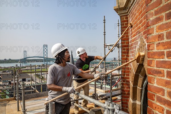 Detroit, Michigan, Anthony Powell (left) and Kevin Driscoll clean and repair the bell towers of the