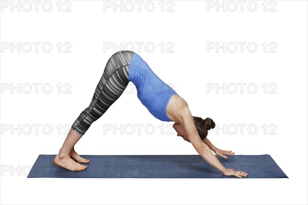 Woman doing Ashtanga Vinyasa yoga Surya Namaskar Sun Salutation asana Adhomukha svanasana, downward