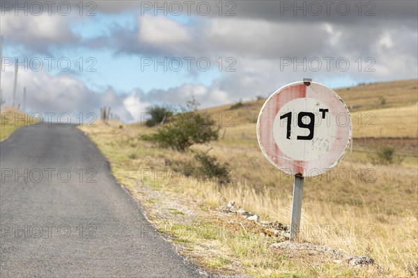 Desolate road in the countryside on a sunny summer day. Cevennes, France, Europe