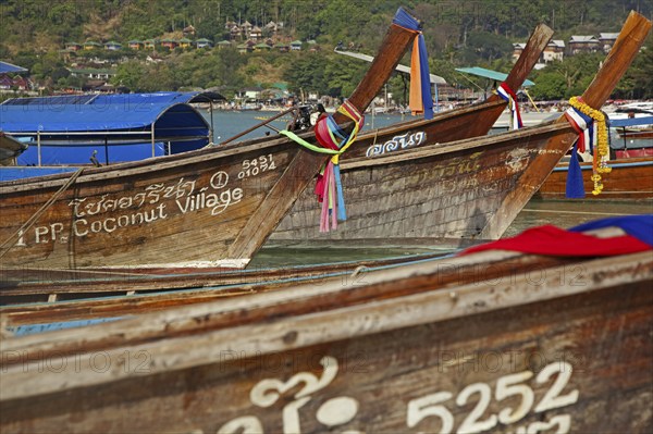 Prows of traditional wooden fishing boats on beach of one of the Ko Phi Phi islands, Southern