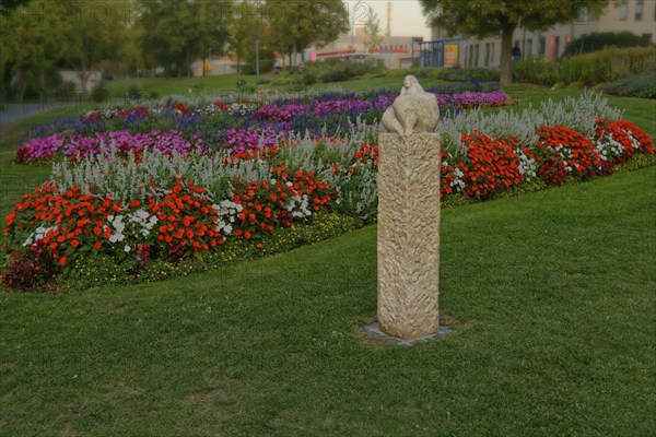 The sculpture Venus of Amberg surrounded by a colourful flower bed in the municipal park, Amberg,