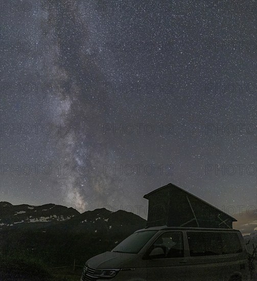 Nocturnal starry sky over the Furka Pass in the Swiss Alps. The night photograph shows the stars of