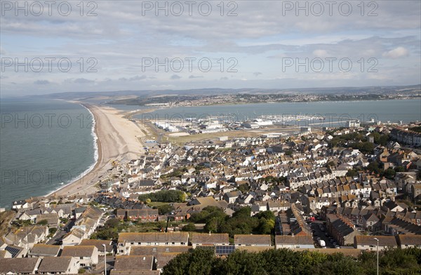 Chesil beach tombolo with housing in Chiswell in the foreground, Isle of Portland, Dorset, England,