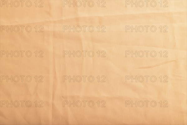 Fragment of smooth orange linen tissue. Top view, flat lay, natural textile background and texture