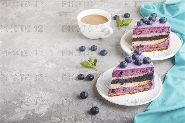 Homemade cake with souffle cream and blueberry jam with cup of coffee and fresh blueberries on a